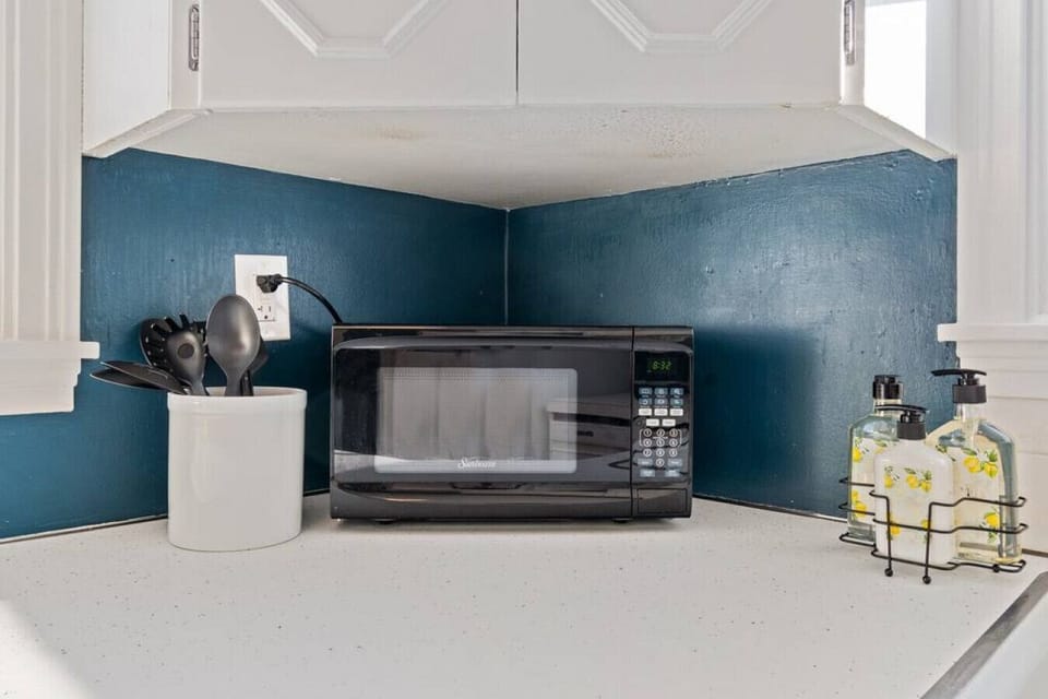Microwave and cooking utensils provided.