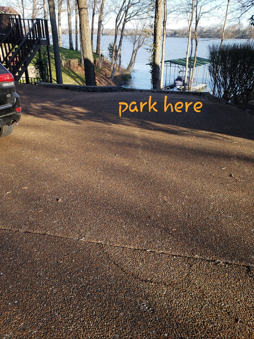 park at the bottom of the driveway facing the dock.