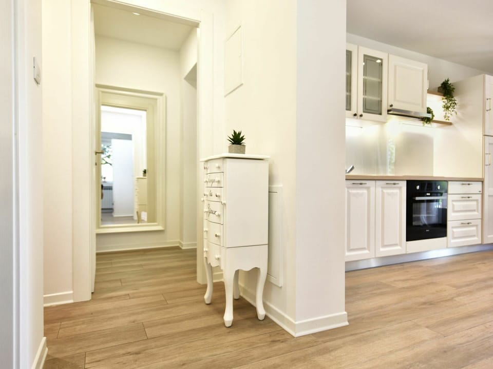 Property, Wood, Lighting, Cabinetry, Interior Design, Hall, Flooring, Floor, Wood Stain, Houseplant