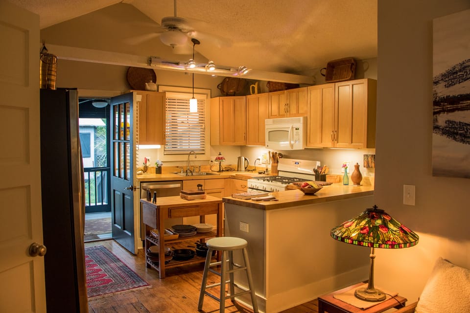 Kitchen with open screen porch door- rear of cottage