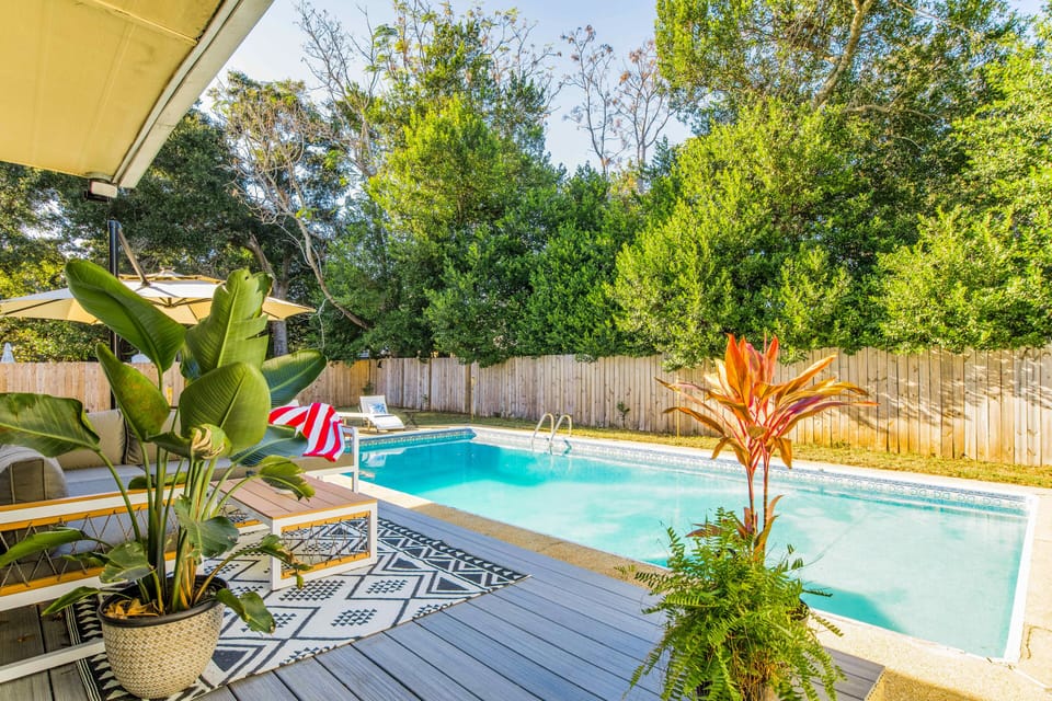 Pool w/deck, loungers, patio furniture and charcoal grill. 