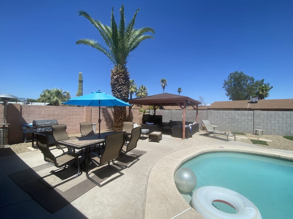 View of the back patio with grill, dining area, diving pool, and Gazebo.