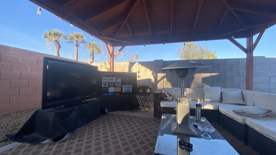 A view of the gazebo in the backyard with TV and Alexa enabled music.