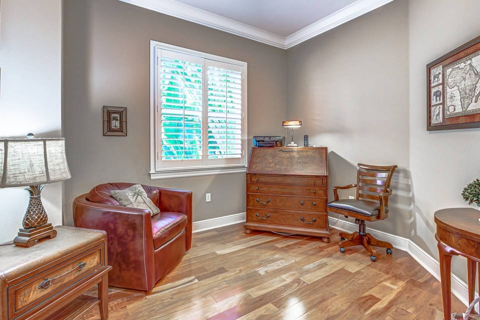 Downstairs den with a work desk and natural lighting.  Lovely wood tile floors.