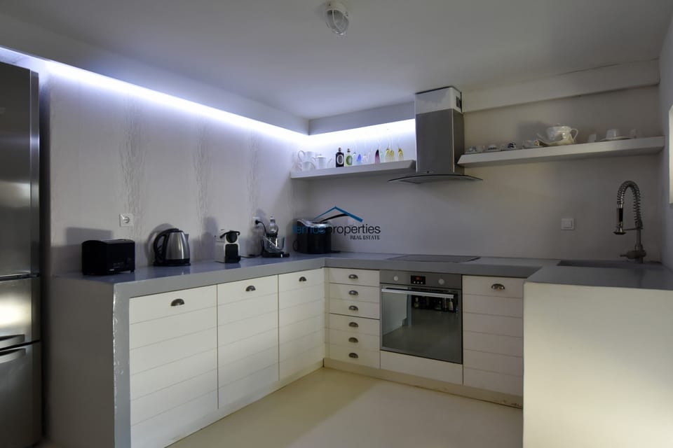 The kitchen near the pool and outdoor dining area