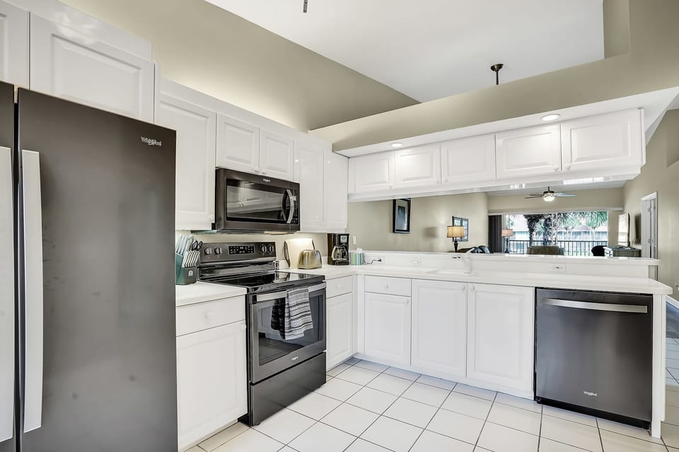 Fully equipped kitchen with newer Whirlpool appliances.