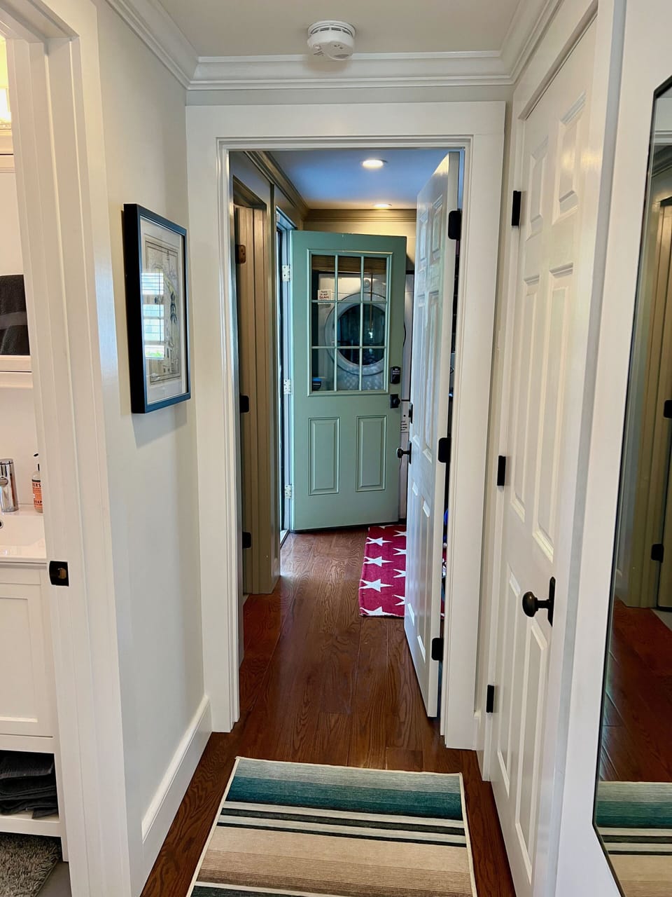 Hallway to Primary Bedroom, Deck and Lower Outdoor space