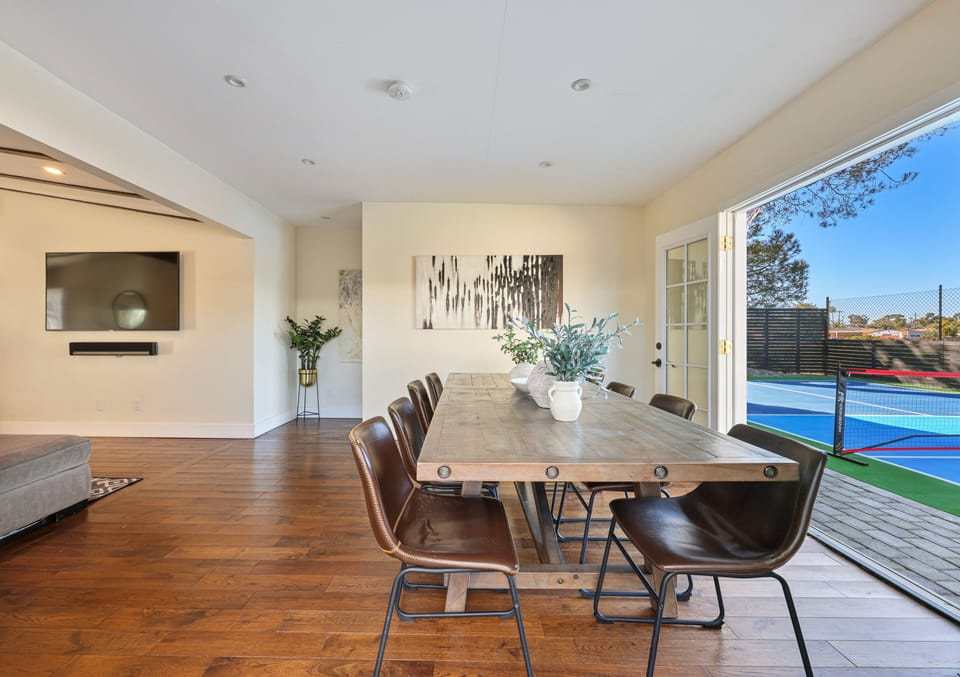 Dinning table with seating for 10 featuring an open layout and French doors