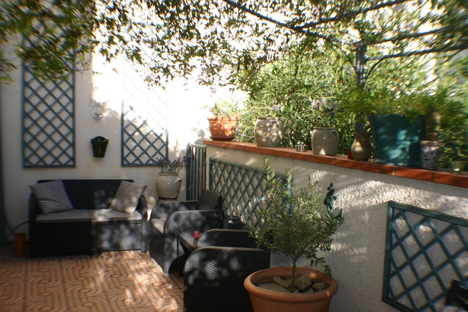 Ground floor terrace with sofa, chairs and outside dinning area 