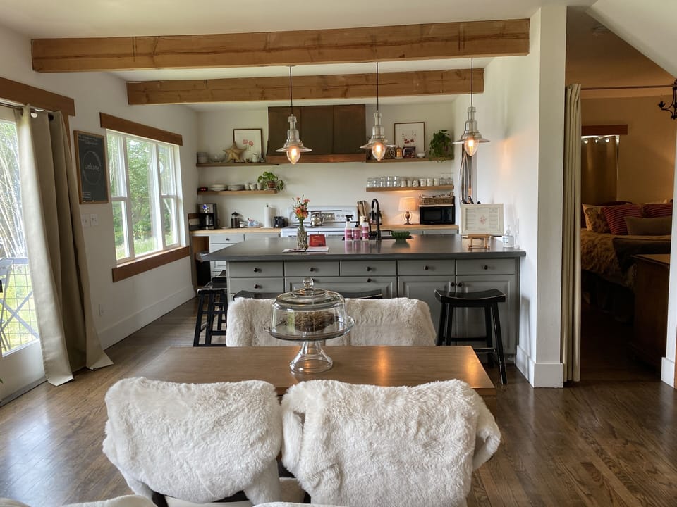 Dining area. 1st floor bedroom drape door way.