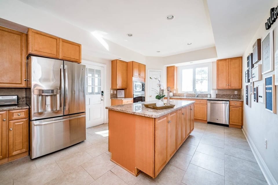 Spacious kitchen with large island is stocked and ready for cooking meals.