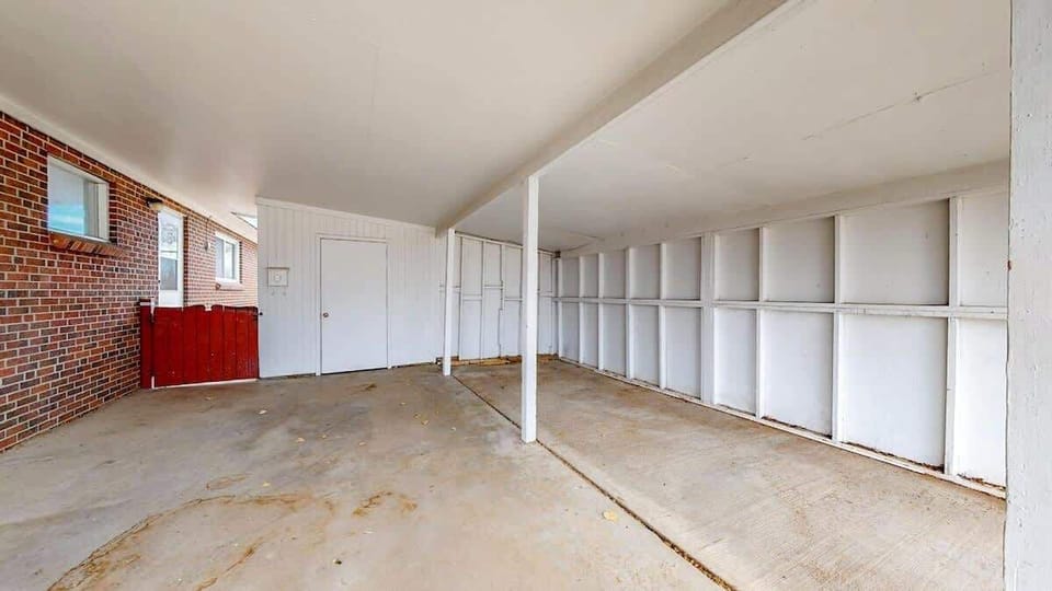 Covered parking area with storage space.