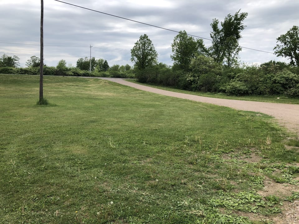 Driveway with large amount of space for cars and boats to park
