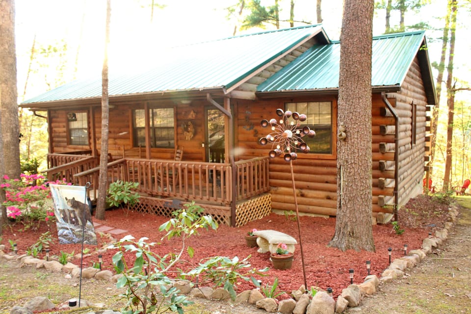 Swing and two rocking chairs on front porch.