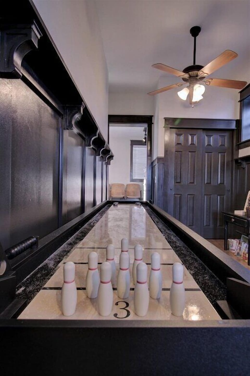 Shuffleboard with additional bowling game 