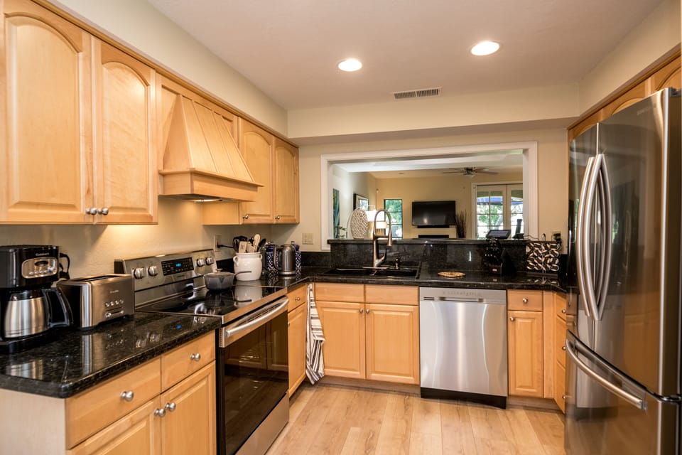The kitchen is stocked with high-end appliances cookware and utensils 