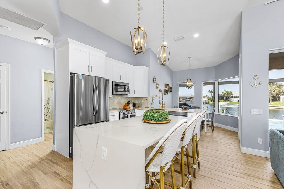 The kitchen is fully equipped & has additional seating for 4
