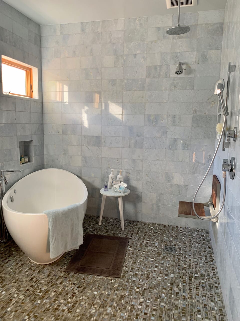 Sophisticated and tranquil marble wet-room style sanctuary with Jacuzzi. 