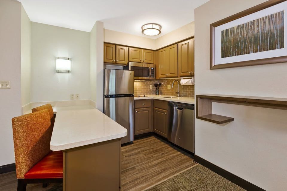 Cook your favorite meals in a modern kitchen with sleek appliances and a comfortable breakfast bar.
