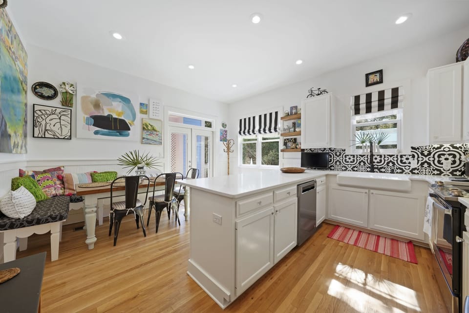 ACROSS FROM OPEN LIVING IS THE RENOVATED KITCHEN & DINING AREA