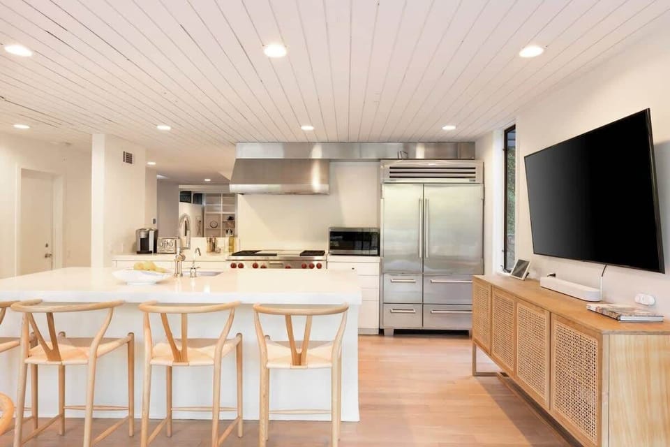 Counter seating, large flat screen TV overlooking the expansive grounds