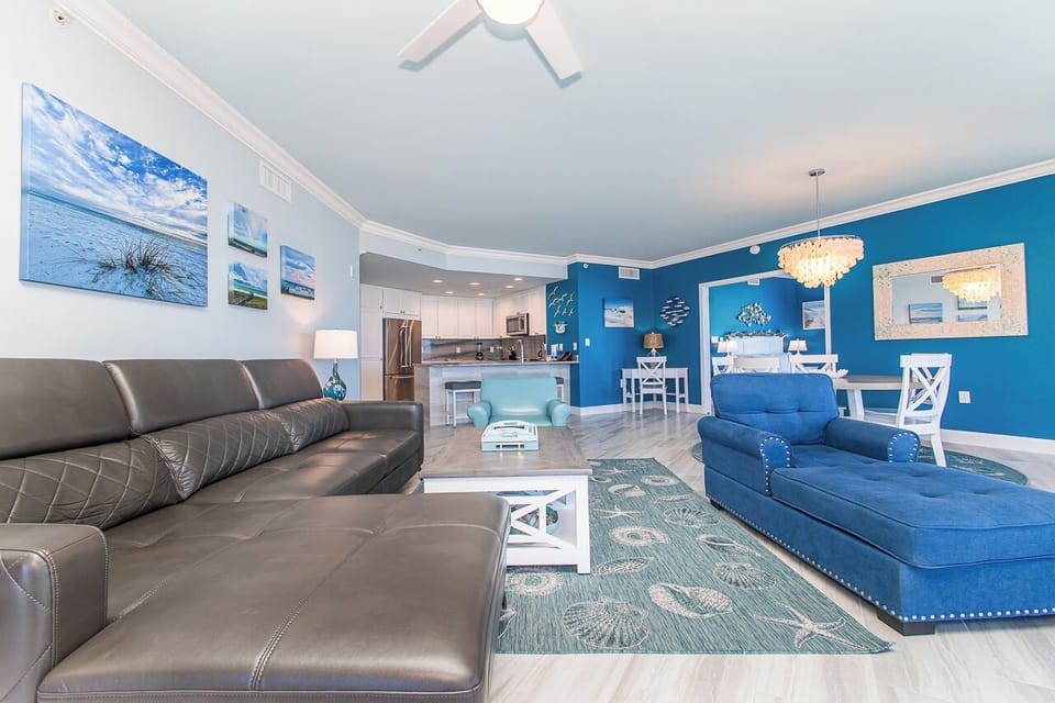 Unwind in your spacious living room with ocean-themed décor, where comfortable seating and coastal artwork create your perfect beachside retreat.