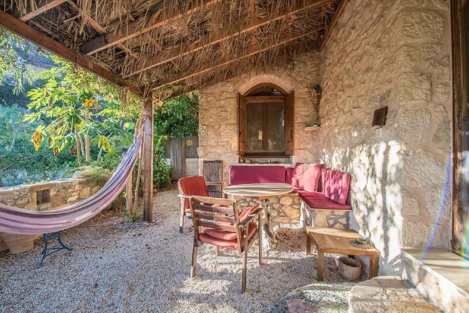 Backyard with table and seating and a hammock for ultimate relaxing times