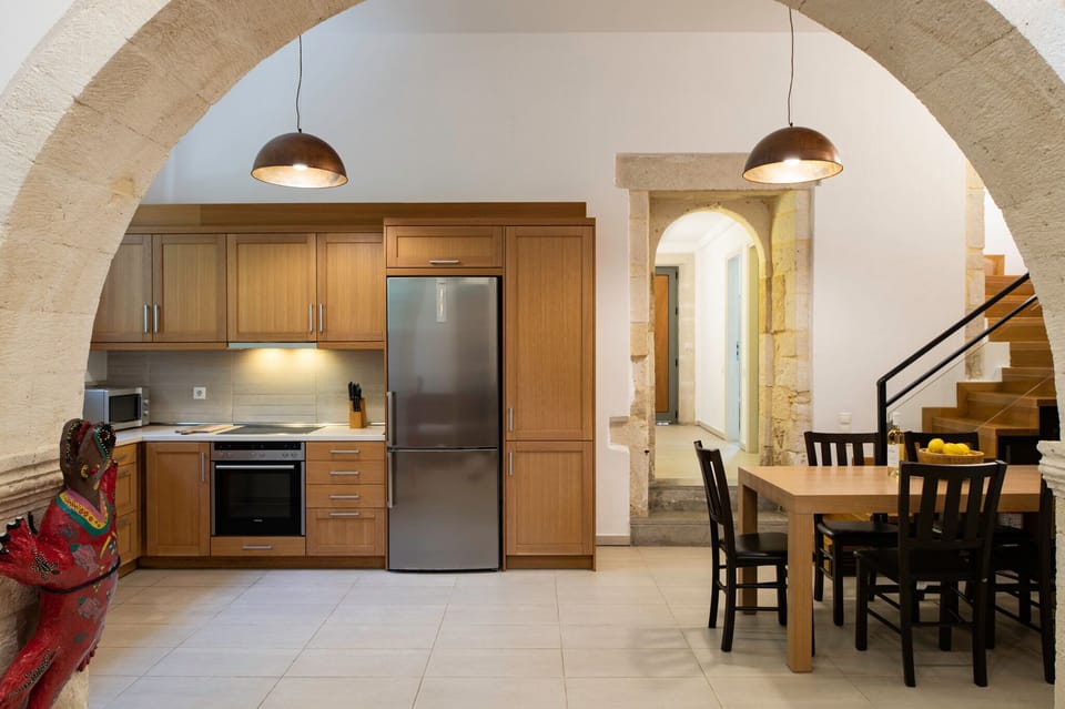Kitchen, dining room, staircase & passage to bedroom and patio-pool.
