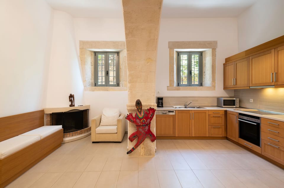 Living room and kitchen divided by the impressive stone arc. 
