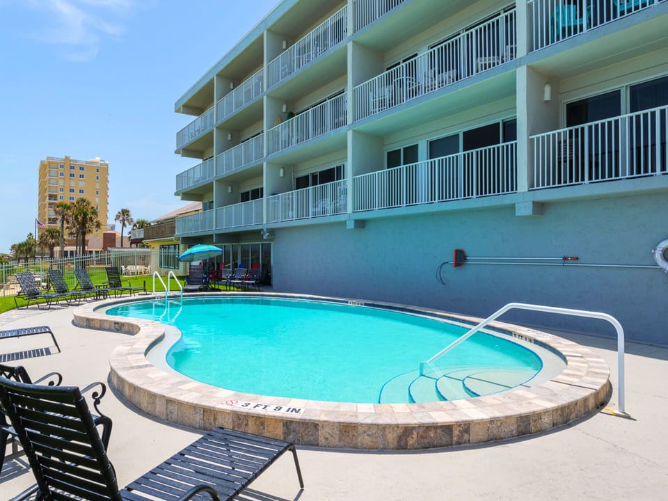 Community Beachfront Pool with Outdoor Dining Tables