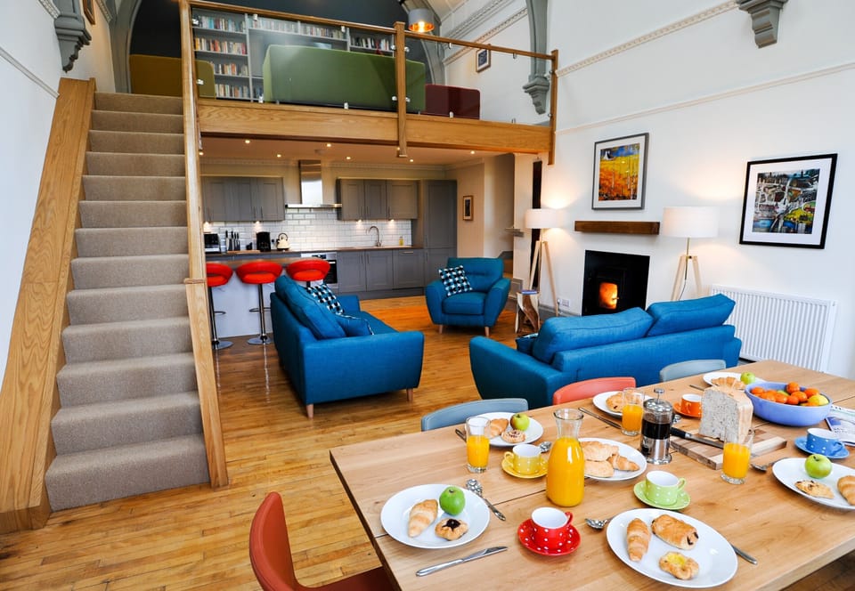 Dining table, seating and log burner, The Five Turrets, Scottish Borders