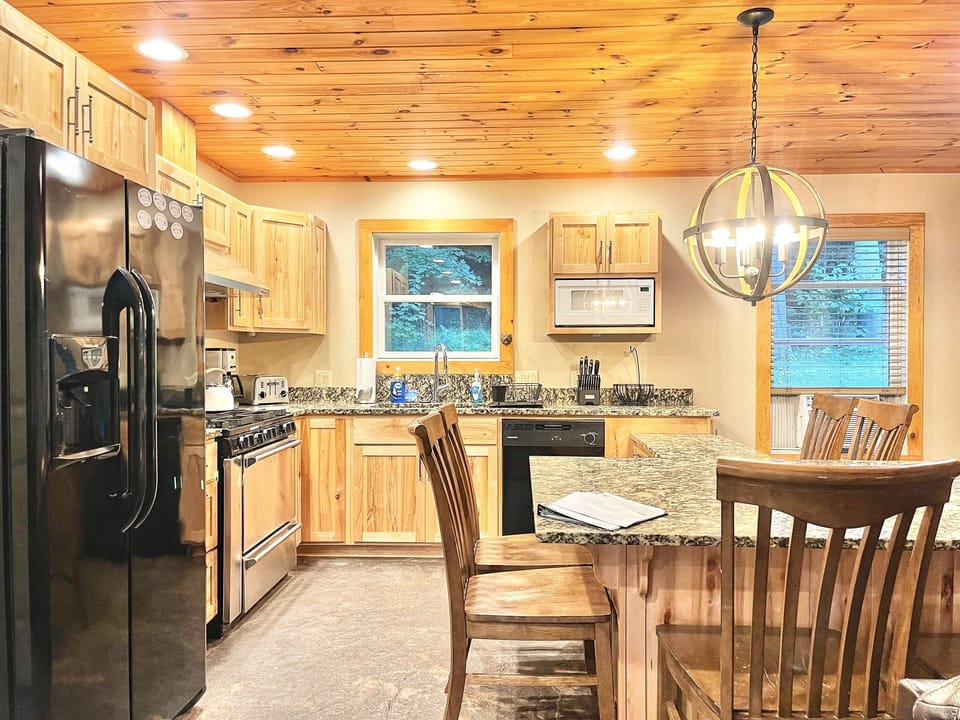 Beautiful kitchen with granite table top has seating for 8.