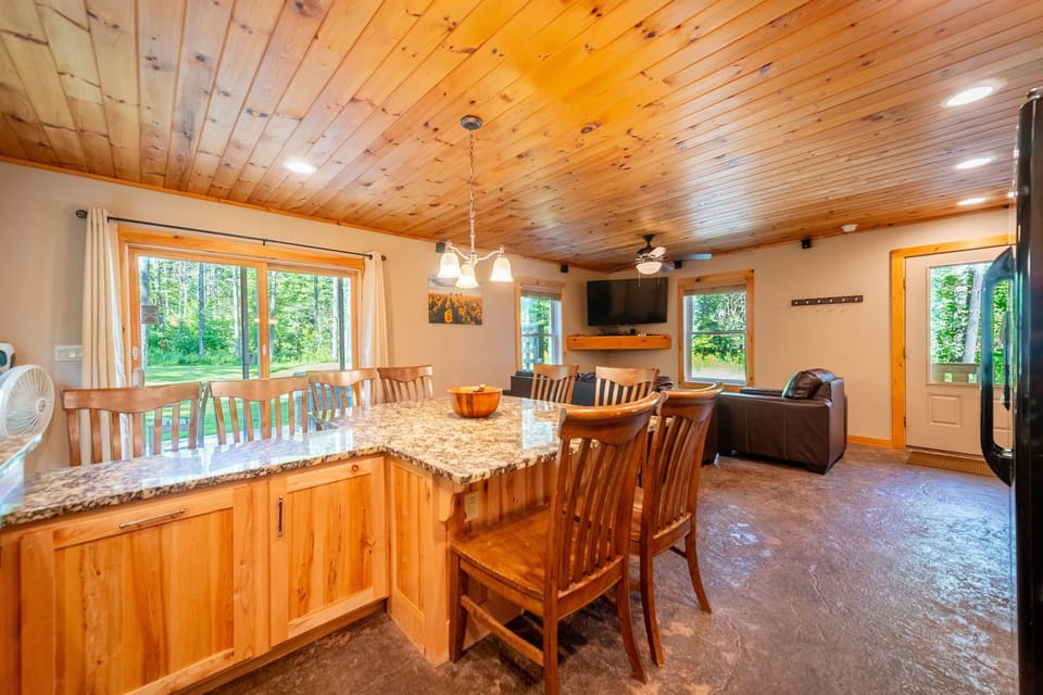 Spacious kitchen bathed in natural light with ample seating.