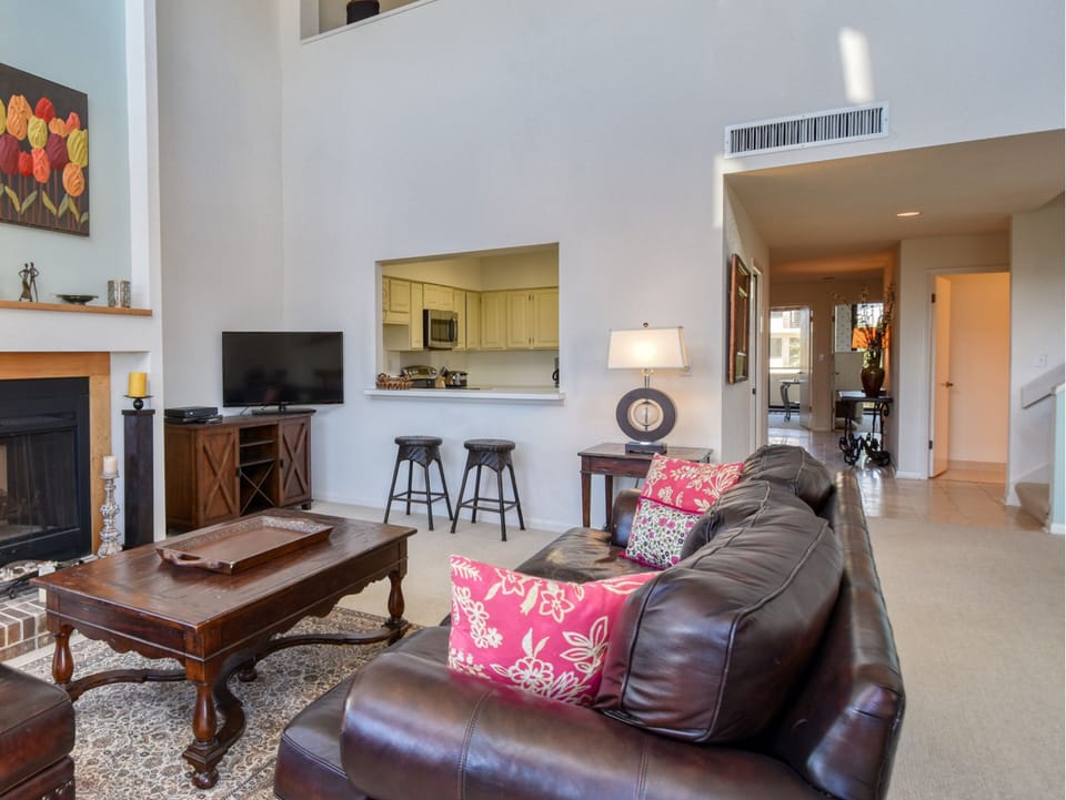 Living Room - Balcony Access, Wet Bar + TV