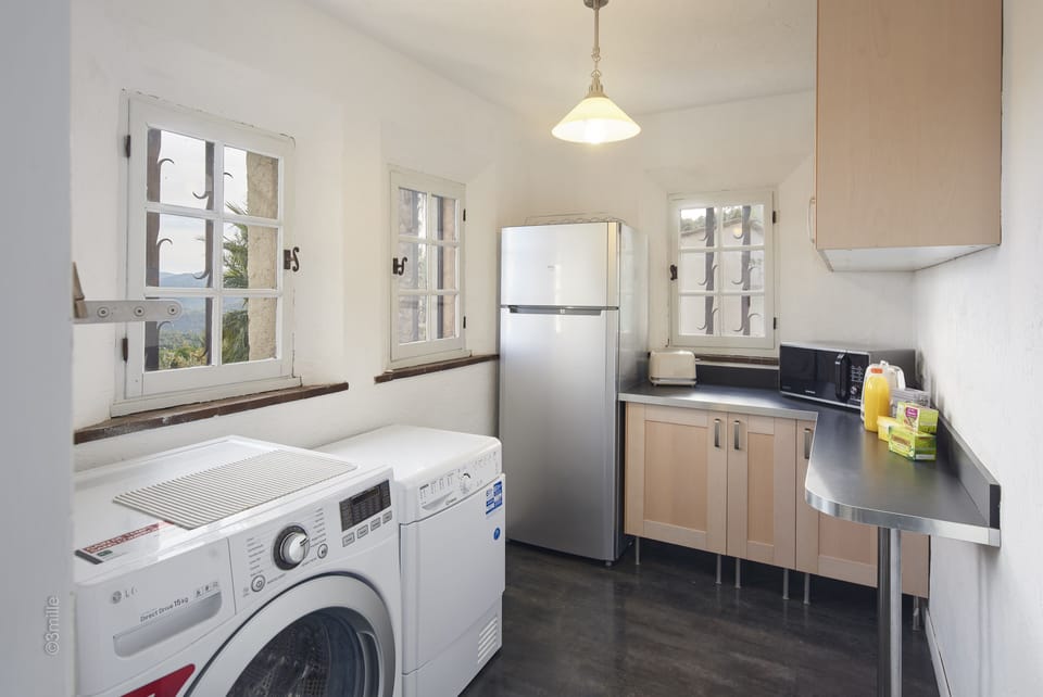 Laundry room/Storage room with fridge and freezer