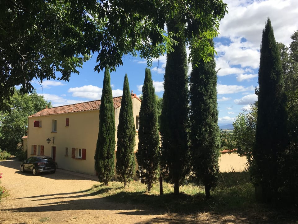 Front of the villa with cypresses
