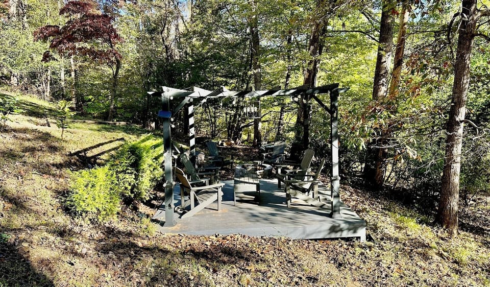 Pergola w/ 4 Adirondack Chairs and Table.