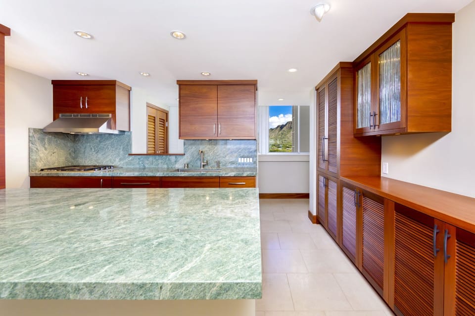 Kitchen - Beautifully finished kitchen with high-end stainless steel appliances and gorgeous green granite counter tops and limestone tiled floors.