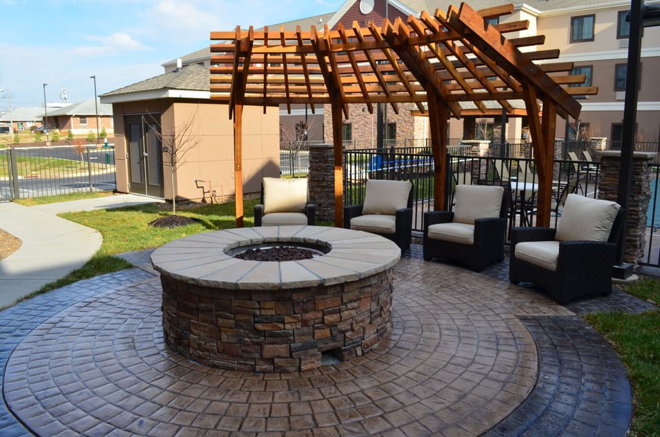 Outdoor fire pit surrounded by comfortable lounge seating.