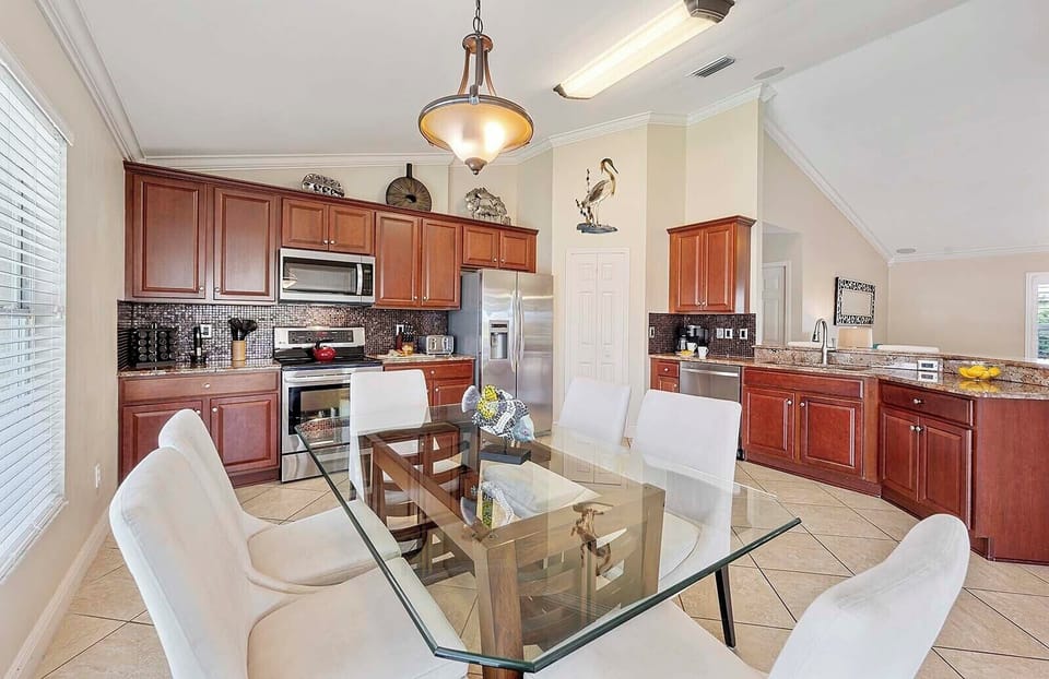 Kitchen with Dining Space and Views of the Lanai and Pool