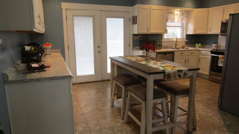 Patio doors open onto large deck with roll-away gate!