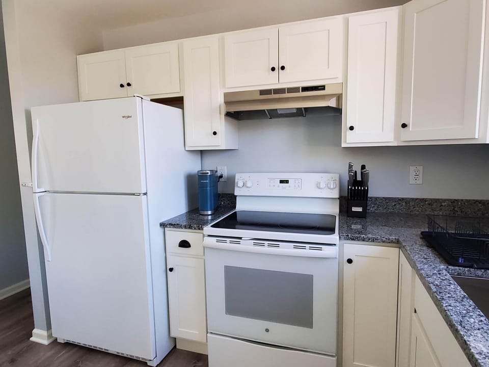 Kitchen is fully equipped with pots/pans, dishes, microwave, dishwasher, coffee 