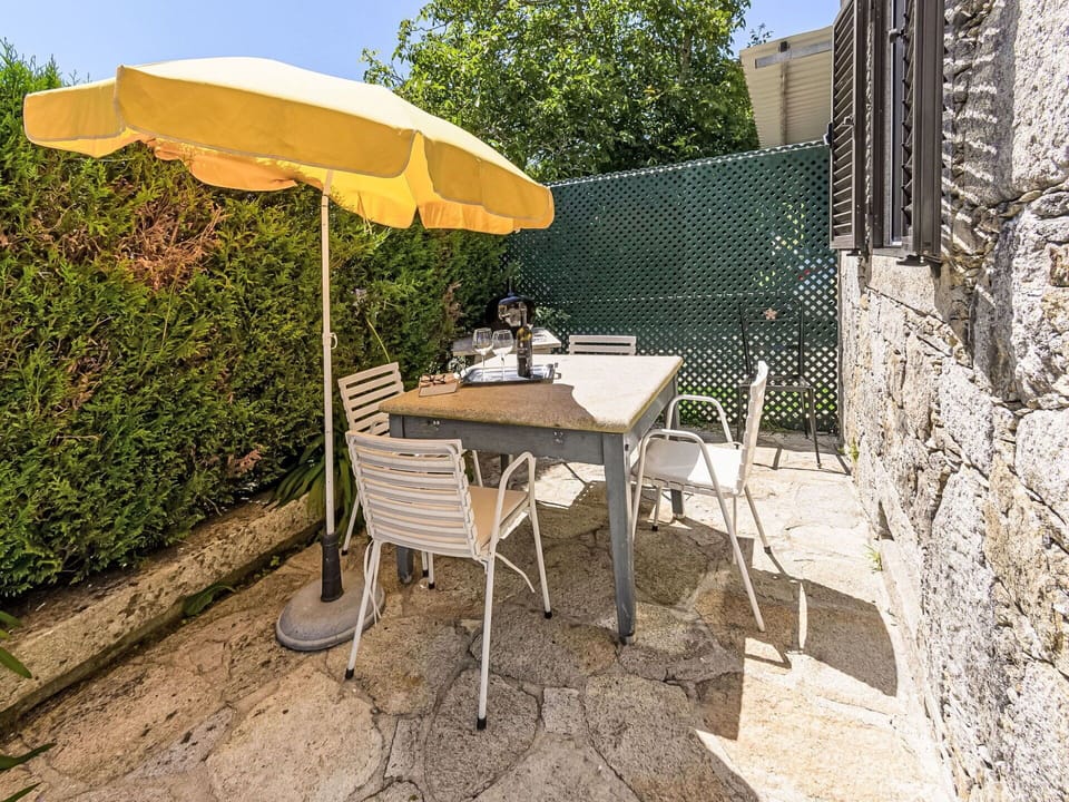 Furniture, Table, Property, Plant, Umbrella, Building, Outdoor Table, Outdoor Furniture, Shade, Chair