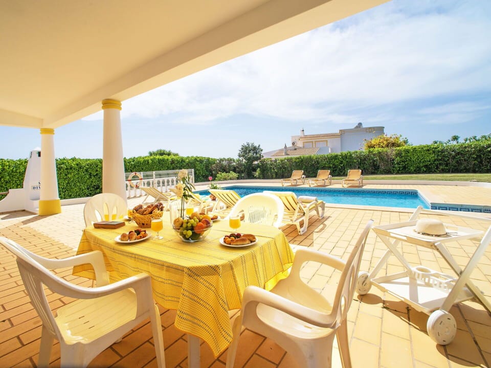 Sky, Furniture, Plant, Water, Property, Table, Building, Chair, Azure, Outdoor Furniture