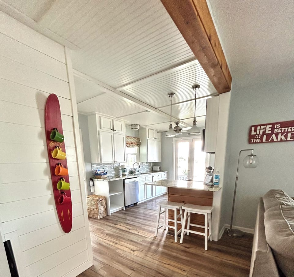 Open concept living/dining room and kitchen, all with lake views