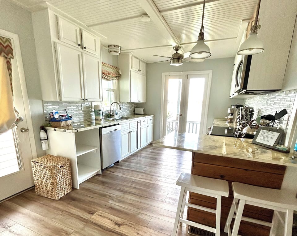 Dishwasher and open storage for your pantry items, lake view as you cook!