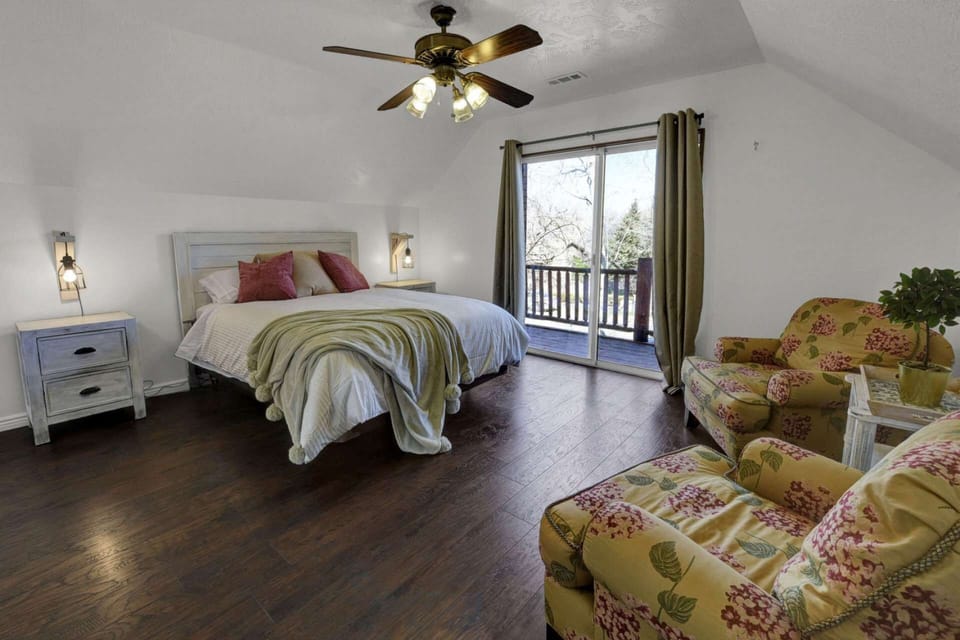 North Side Guest Bedroom with Queen Bed, Private Balcony, and Feather Stuffed Sitting Chairs to enjoy a Cup of Coffee to start the Day.