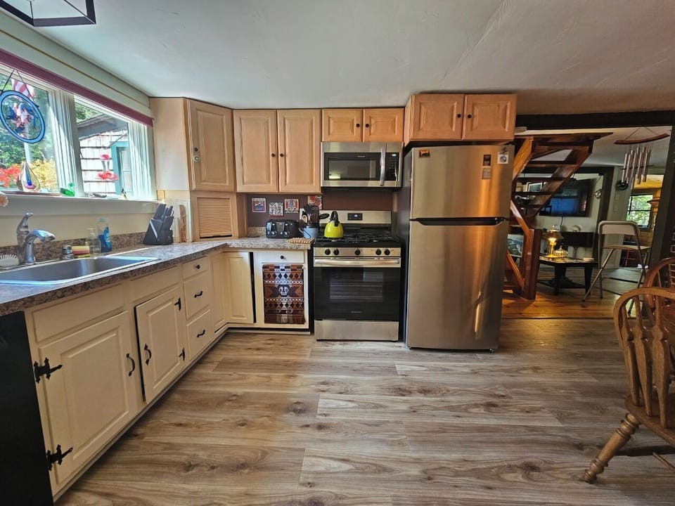 spacious kitchen new appliances, new floor open to other areas 