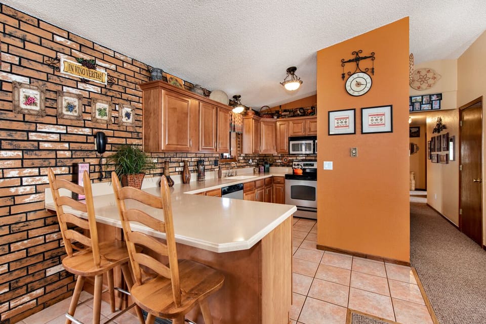 Kitchen, bar and hallway leading to bedrooms