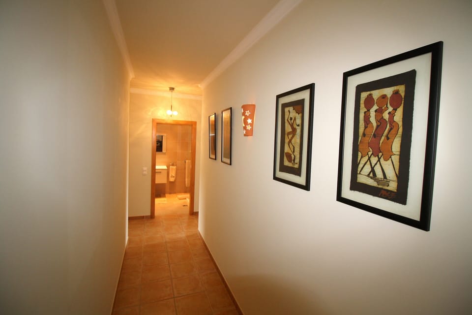 The bathroom is at the end of the hallway